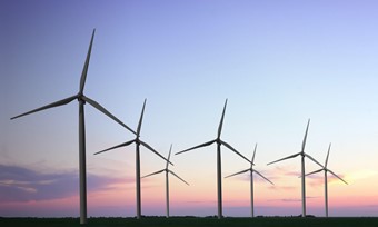 Turbines making up a wind farm in the evening sun